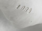 an image of a close up of a white vase with a bird on it