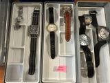 many different watches in the box on the table