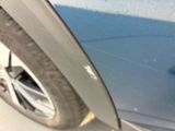 a close up of a car ' s tire on the side of the road