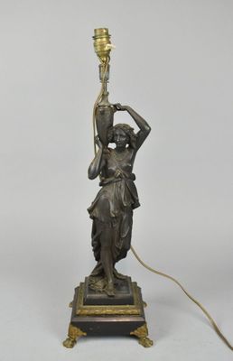 an image of a bronze statue of a woman holding a lamp