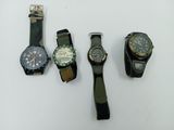 three different watches are sitting on a white surface with a white background