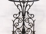 an antique cast iron shelf with a marble top on a white background