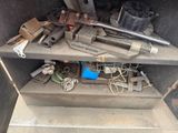 a pile of tools sitting on a shelf in the back of a truck