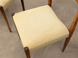 pair of mid - century danish chairs with upholstered cushions