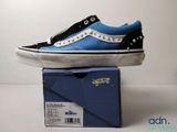 a pair of blue and black shoes sitting on top of a box