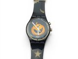a black watch with a pumpkin on it on a white surface