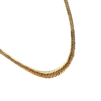 a gold necklace with a chain on a white background