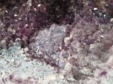 a close up picture of a cluster of purple crystals