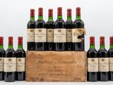 a group of six bottles of red wine in a wooden crate