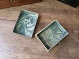 two small boxes that are sitting on a table