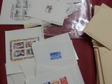 many envelopes and stamps laid out on a table