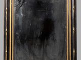 an antique black and gold framed mirror with a black background
