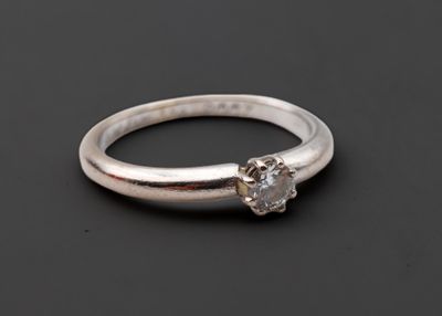 gros plan d'une bague en diamant sur une surface noire