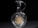 a clear glass vase with a gold design on it