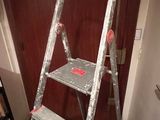 a ladder that is leaning against a wall in a room