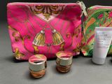 a pink bag with a lot of cosmetic items on it