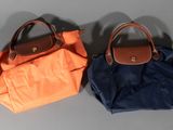 two purses that are sitting on a table