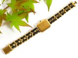 gold and black chain bracelet with a gold clasp