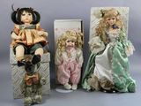 three dolls sitting next to each other on a table