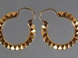 gold plated hoop earrings with pyramids on them