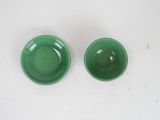 pair of green bowls on a white surface