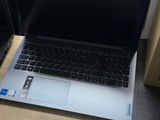 a laptop computer sitting on a desk in front of a chair