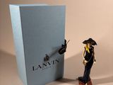 a figurine of a man standing next to a blue box