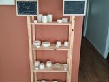 a shelf that has a chalk board on top of it