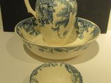 a blue and white bowl and a pitcher on a table