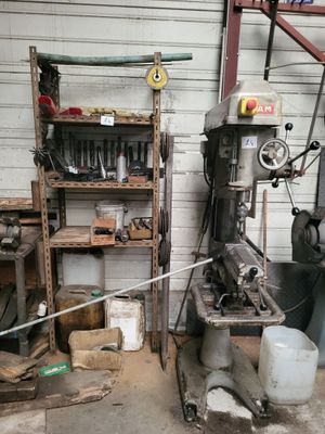 a machine that is sitting in a garage next to a shelf