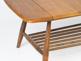 a wooden coffee table with a magazine rack underneath it