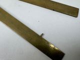two pieces of brass that are on a table