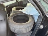two tires in the back of a car with the door open
