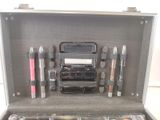 a silver case with a lot of makeup items inside of it