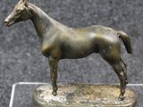 bronze statue of a horse on a clear base on a black background