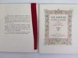 an open book with a red ribbon on top of it