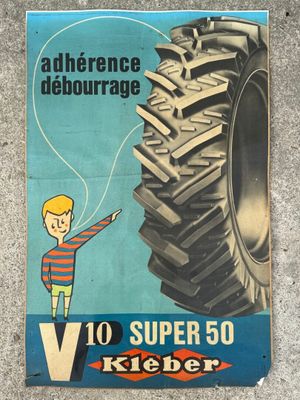an advertisement for a tractor tire with a boy pointing to it