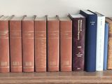 many books that are on a shelf in the room