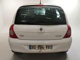 a small white car that is parked in a garage