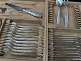 a wooden box with silverware in it and a knife, fork, spoon, and spoon rest