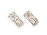 a pair of silver earrings on a white background