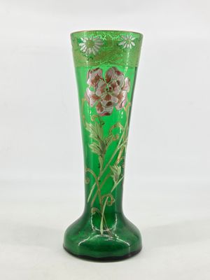green glass vase with a floral design on the bottom