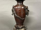 a vase that has a dragon on it