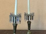 pair of antique brass candlesticks with crystals on top of a wooden table