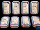six plastic containers with different colored lids are lined up on a black surface