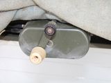 a metal container with a wooden handle underneath a blanket