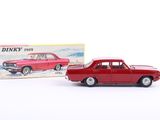 a red toy car sitting next to a boxed box