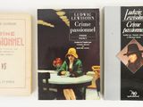 three books sitting on a table next to each other on a white surface