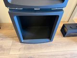 an image of a blue oven sitting on top of a wooden floor