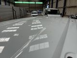 many cars parked inside of a large building